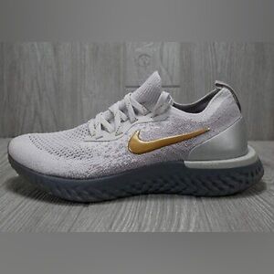 Nike Women’s Flyknit Running Sneakers in Light Gray with Gold Swoosh